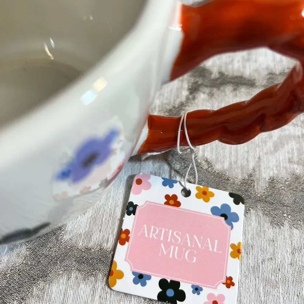 Artisan Mug with Floral Design and Orange Handle